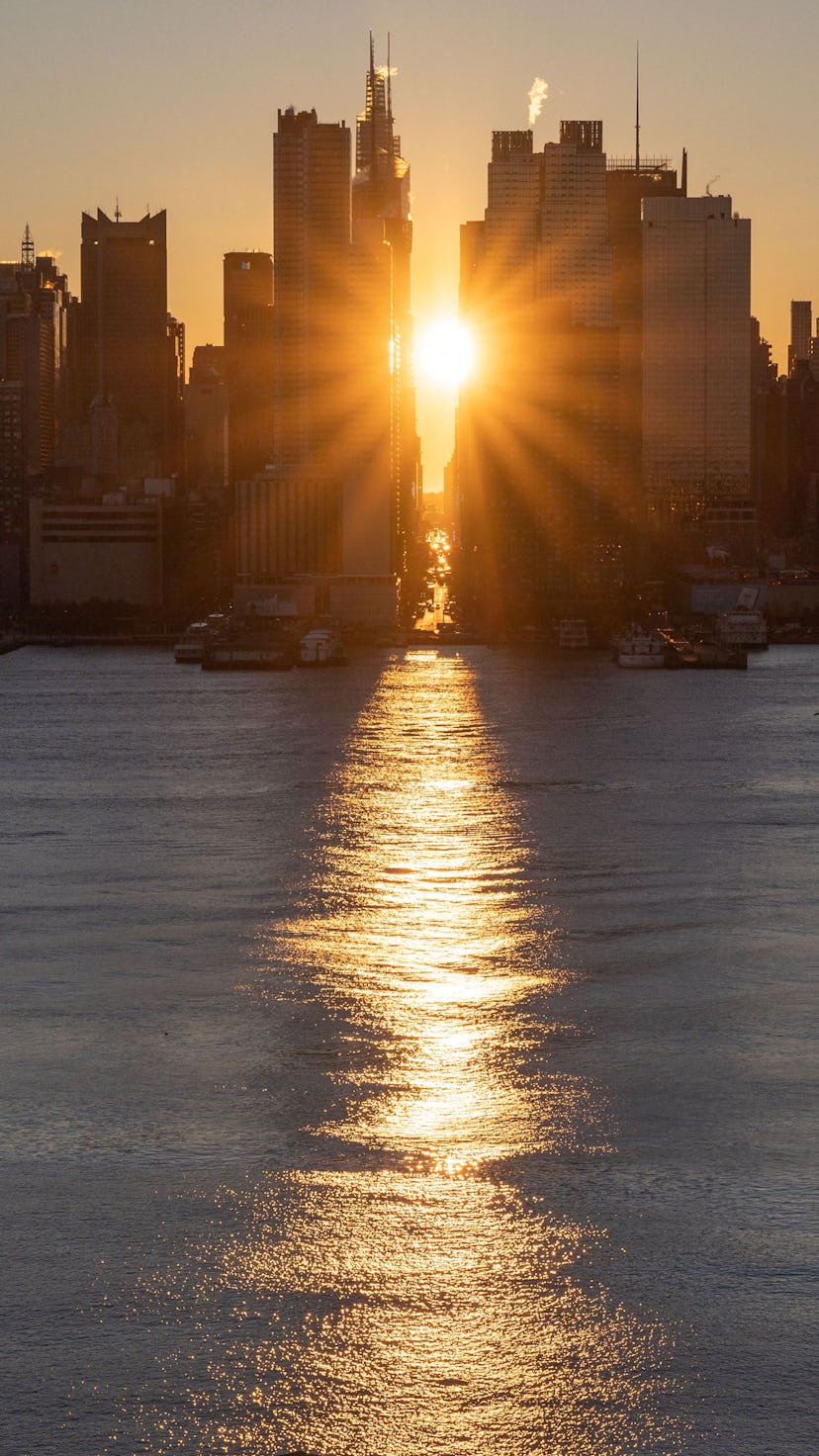 The sun rises above 42nd Street during a reverse 'Manhattanhenge' in New York, New York. The Senate ...