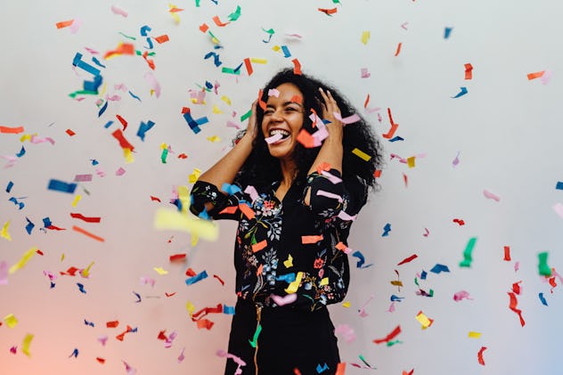 woman surrounded by confetti, April Fools' pranks to play on your wife