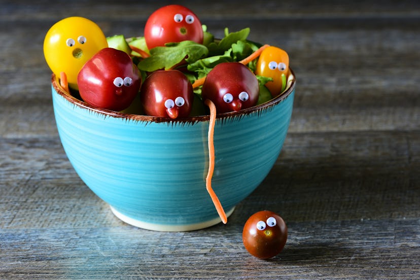 Tomato with googly eyes escaping from a bowl of salad in a list of April Fools' Day pranks to play o...