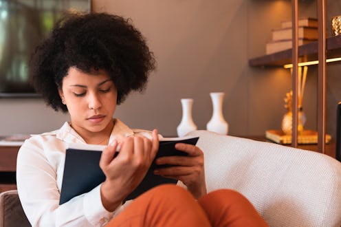 woman reading a book in her living room