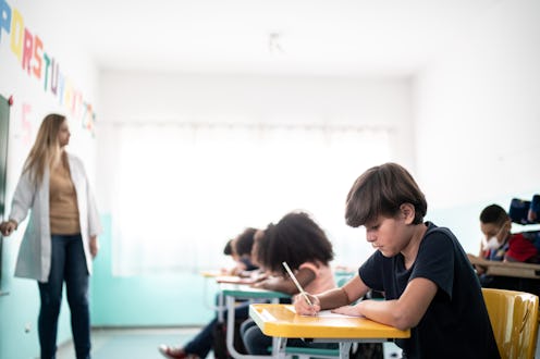 Boy taking notes in the classroom