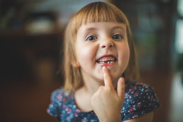 Portrait of a cute little girl with a wonderful toothless smile