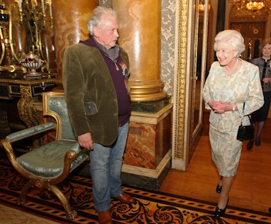 Queen Elizabeth II meets photographer David Bailey at a reception for the British Clothing Industry,...