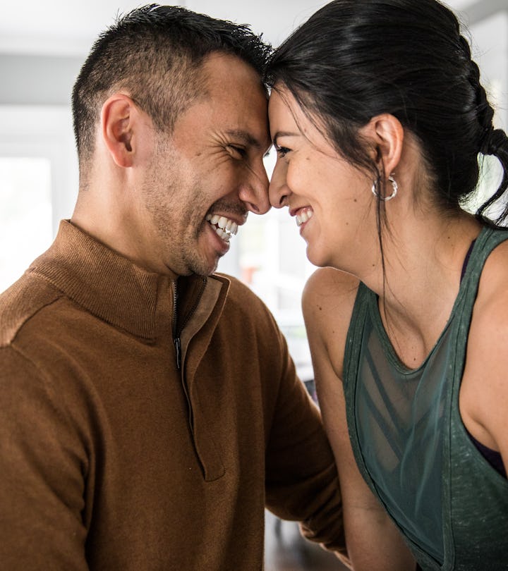 Husband and wife hugging in kitchen