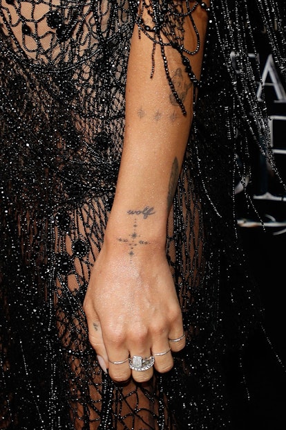 Zoe Kravitz tattoos include a dainty cross on each wrist.