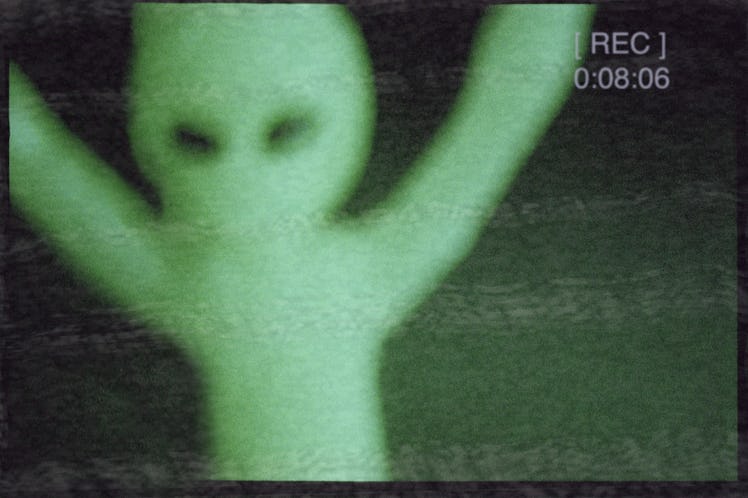 green alien on film camera