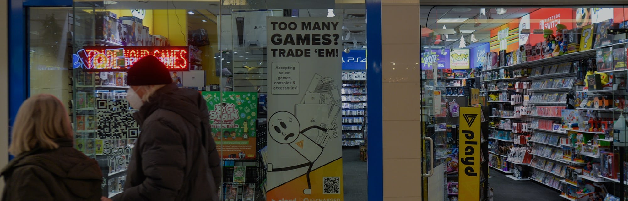 A couple walks past the entrance to the Game Stop store inside a shopping mall in Edmonton.
On Thurs...