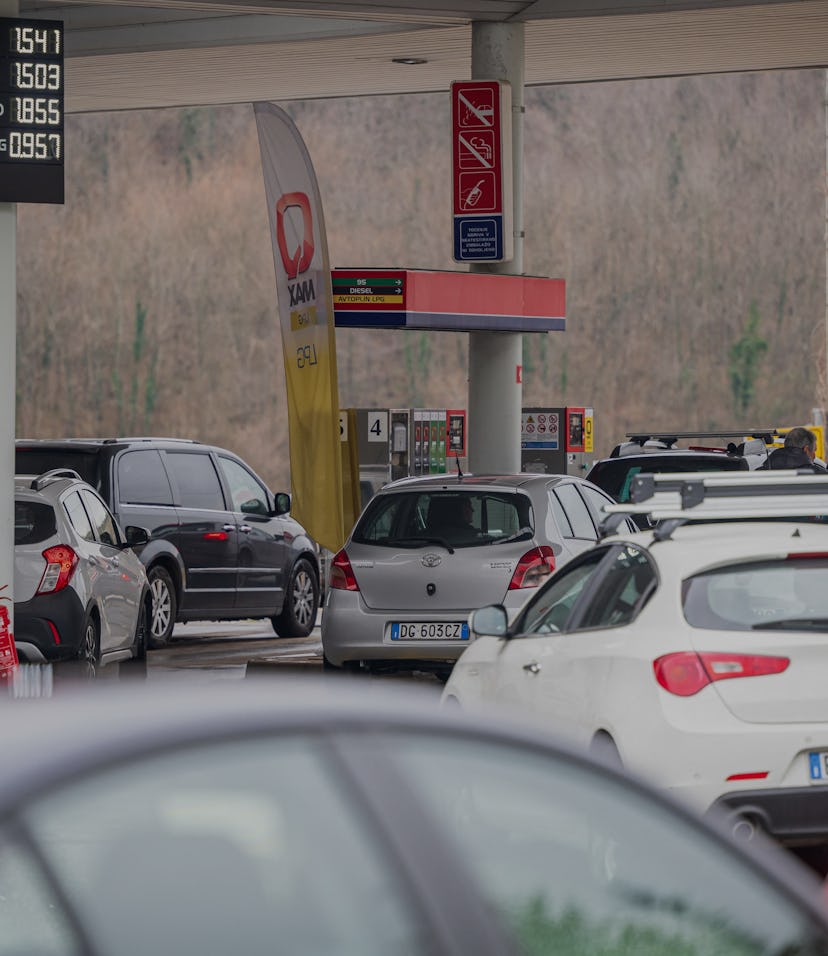 Drivers, mostly from Italy, wait in their cars to benefit from lower prices as they queue to enter t...