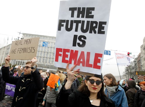 Inspiring woman holding a quote sign that says "The future is female."