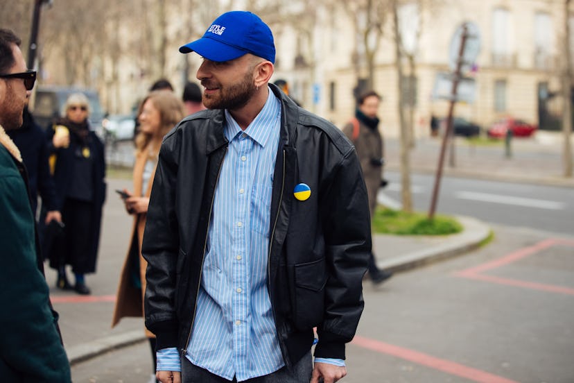 PARIS, FRANCE - MARCH 01: Beka Gvishiani of StyleNotCom wears a blue StyleNotCom cap, black leather ...
