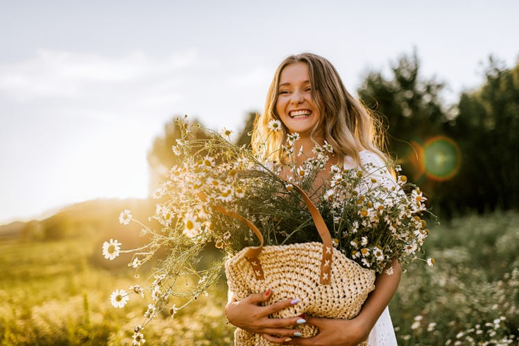 Young adult woman enjoying spring and using spring puns for captions on Instagram.