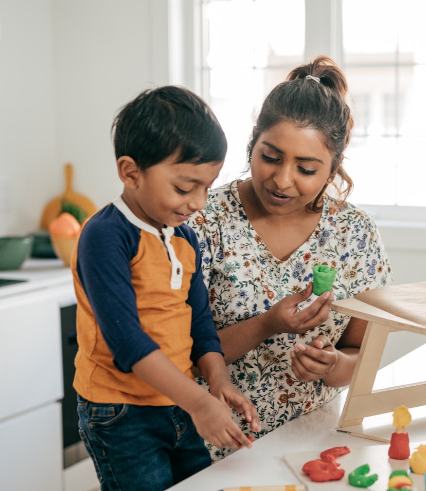 Mom and son play together, in a story about Instagram captions for National Sons Day.