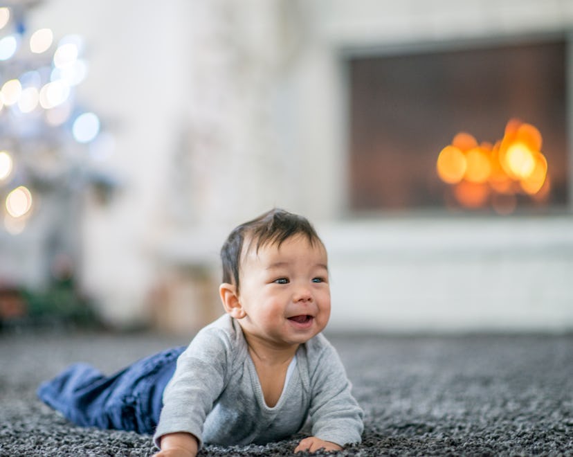 baby boy on the floor in front of a fireplace