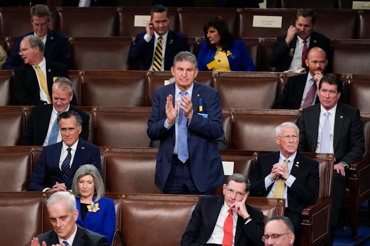 Sen. Joe Manchin, D-W.Va., stands and applauds as he sits among Republican Senators as President Joe...