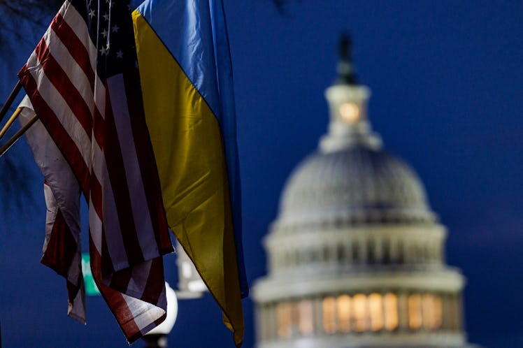 WASHINGTON, DC - MARCH 01: The U.S. Capitol building can be seen past American and Ukrainian flags t...