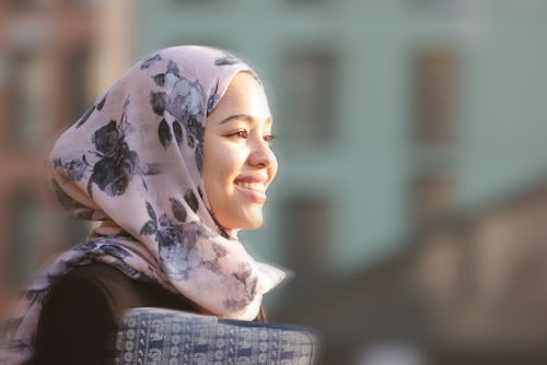 A woman wearing hijab smiles while walking down the street. Here's your daily horoscope for March 3,...