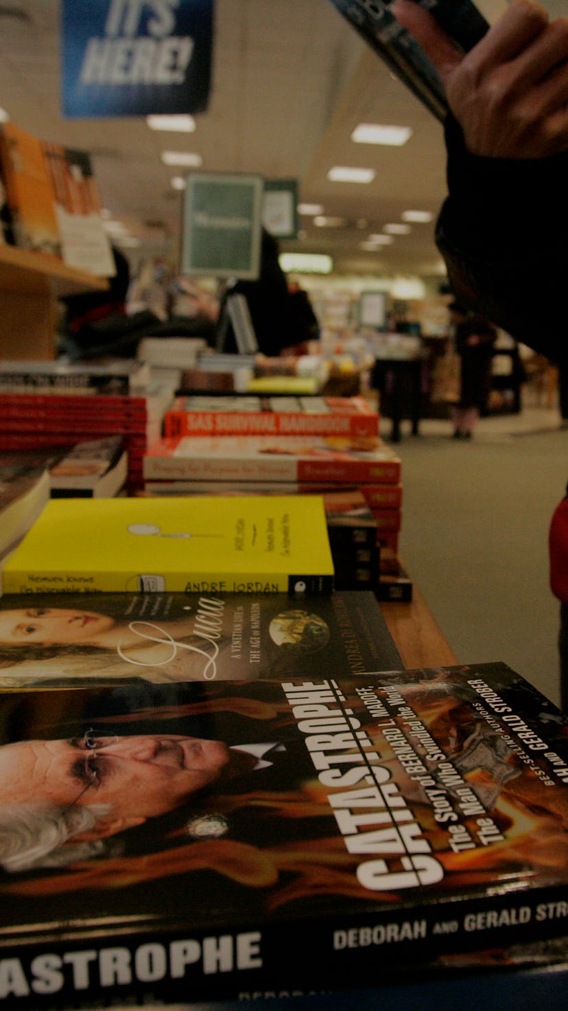(031309 Boston, MA) A shopper looks over a book at a display table featuring copies of 'Catastrophe'...