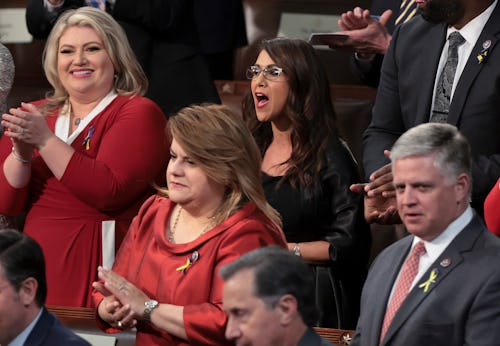 WASHINGTON, DC - MARCH 01: Rep. Lauren Boebert (R-CO) (C) stands with fellow lawmakers as they liste...