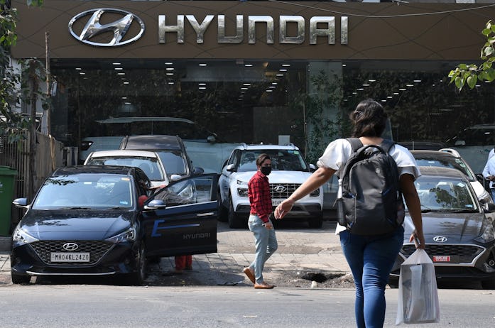 MUMBAI, MAHARASHTRA, INDIA - 2022/02/09: People are seen walking outside the Hyundai car showroom in...