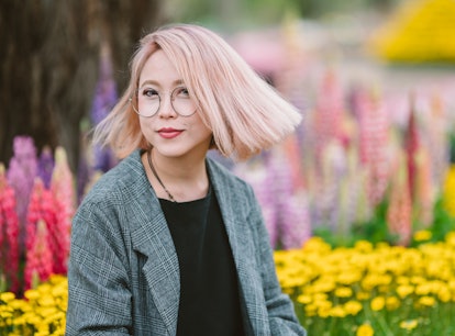 A woman with pink hair in the spring uses hair quotes for Instagram for her spring hair captions.