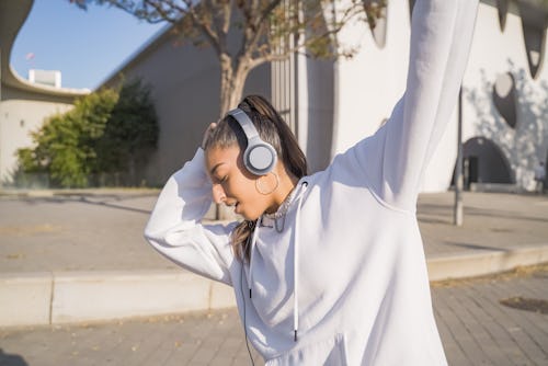 A woman listens to her Spotify Zodiac Affinity playlist in her headphones; spotify zodiac affinity g...