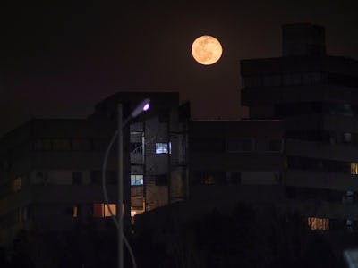 Bloody moon shines on residential complexes in the west of Tehran on the eve of Nowruz on March 19, ...