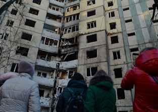KYIV, UKRAINE - MARCH 20, 2022 - People face a residential building in Sviatoshynskyi district affec...