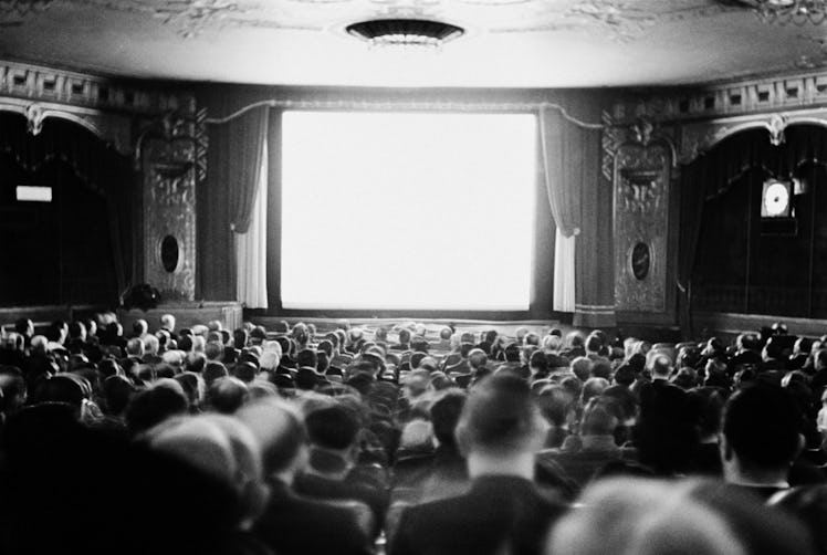 black and white audience watching movie screen