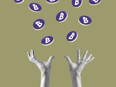 Hands catching Bitcoin coins that are falling