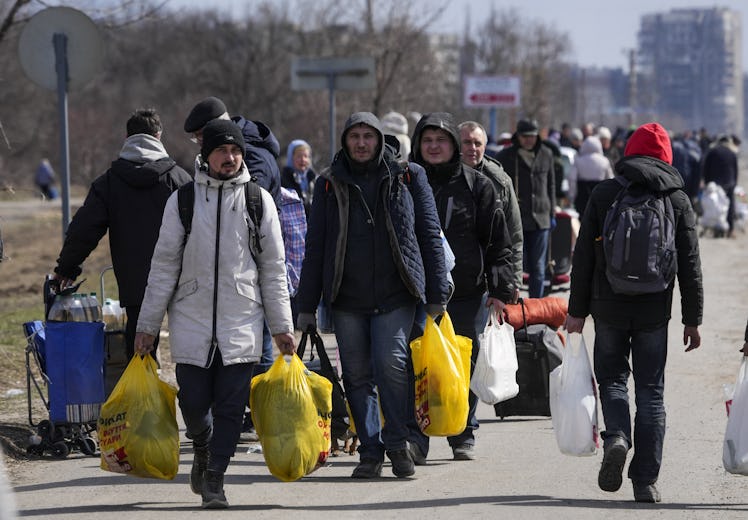 Civilians being evacuated along humanitarian corridors from the Ukrainian city of Mariupol besieged ...