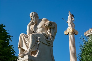 Athens, Greece- May 2, 2014 : Statue of Socrates with the Athena column in the background,by sculpto...