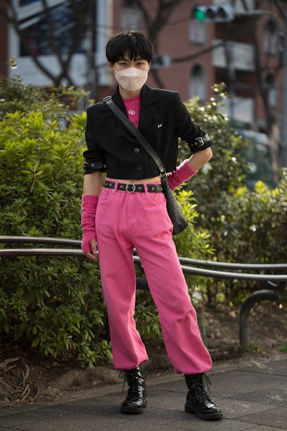 TOKYO, JAPAN - MARCH 16: A guest is seen wearing black crop jacket with pink crop sweater, pink knit...