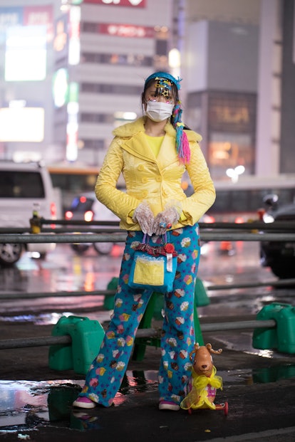 TOKYO, JAPAN - MARCH 19: A guest is seen wearing decora outfit with yellow coat, multi-color print p...
