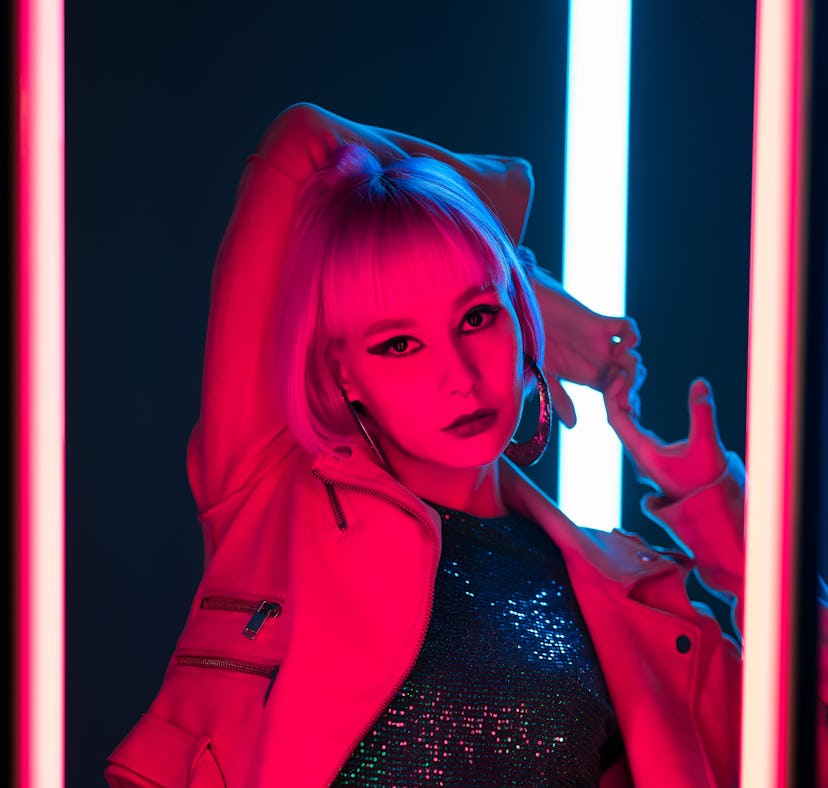 young woman strikes a pose as she thinks about the emotional meaning of the April 2022 full Pink Moo...