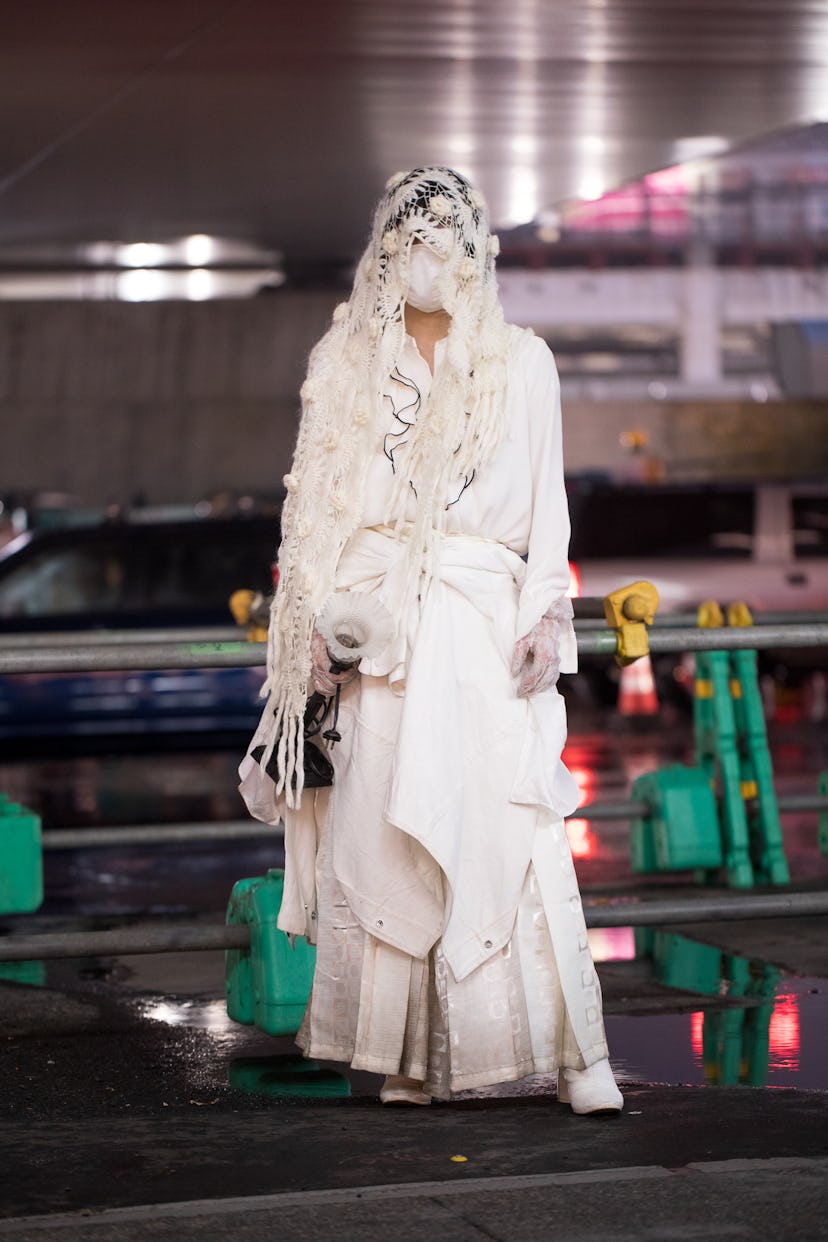 TOKYO, JAPAN - MARCH 19: A guest is seen wearing all-white outfit with knit lace scarf, and vintage ...