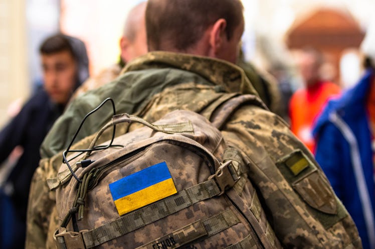 LVIV, LVIV OBLAST, UKRAINE - 2022/03/22: The Ukraine flag on the back of a soldiers backpack. As the...