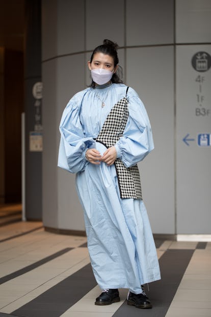 TOKYO, JAPAN - MARCH 15: A guest is seen wearing baby blue dress with houndstooth print accent piece...
