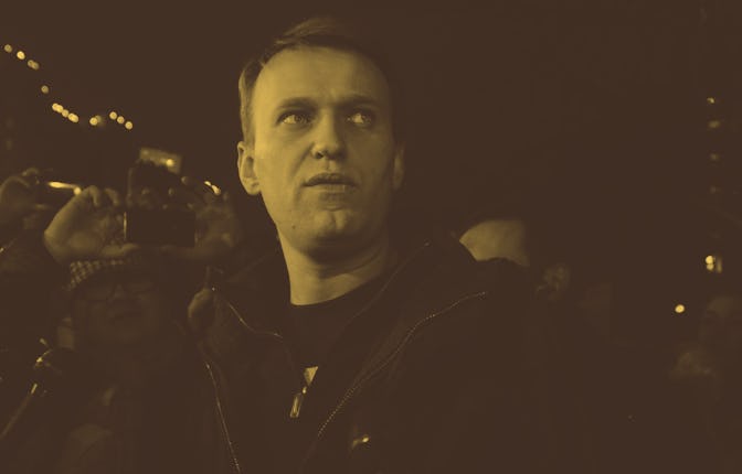 Anti-Kremlin blogger Alexei Navalny speaks to journalists and supporters outside a police station in...