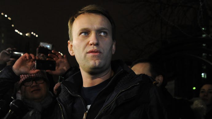 Anti-Kremlin blogger Alexei Navalny speaks to journalists and supporters outside a police station in...