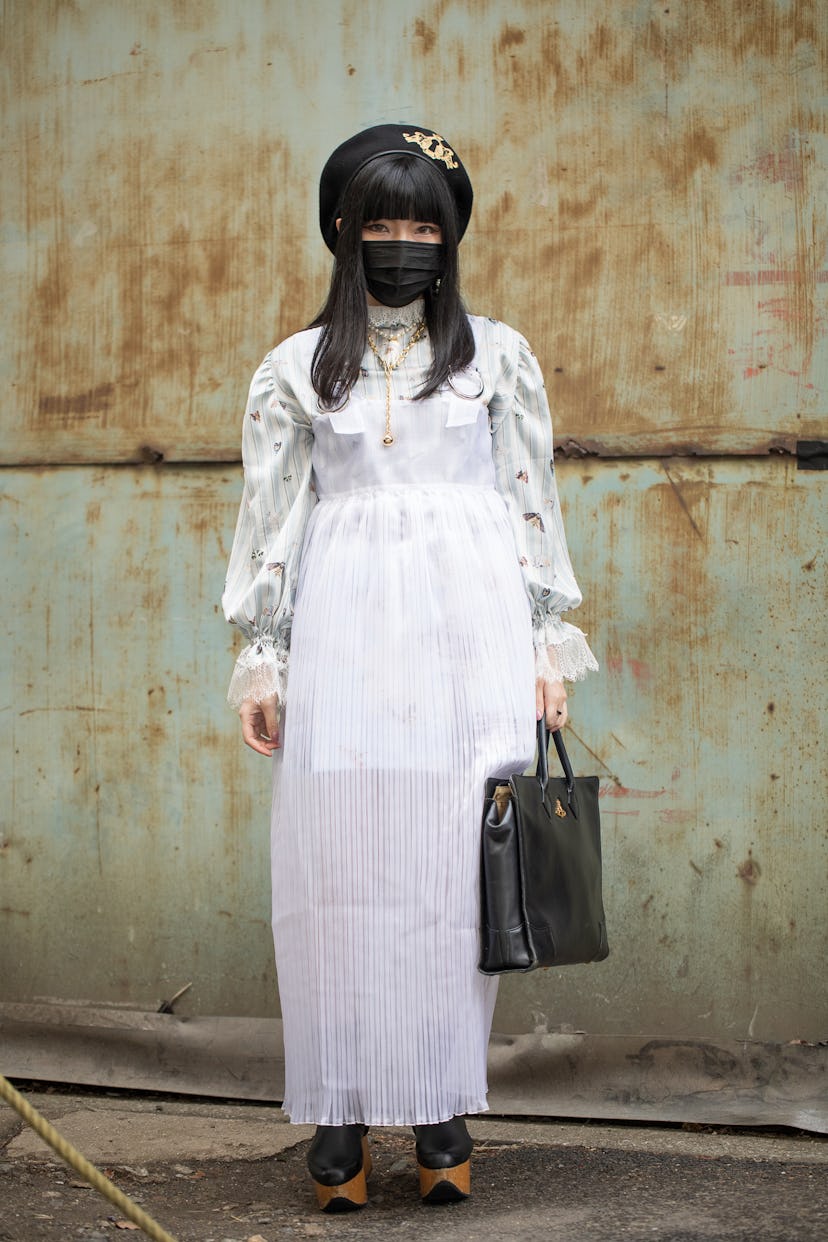TOKYO, JAPAN - MARCH 19: A guest is seen wearing moth print blouse, black beret, sheer dress, black ...