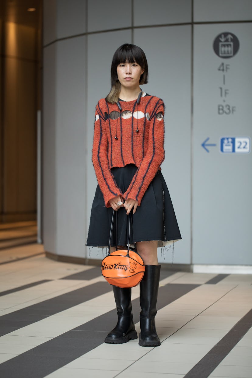 TOKYO, JAPAN - MARCH 15: Yoshiko Kurata is seen wearing red and navy stripe sweater, black skirt, bl...