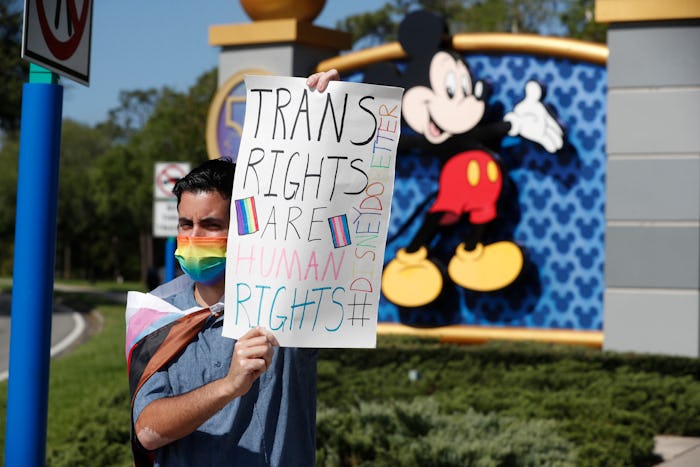 ORLANDO, FL - MARCH 22: Disney employee Nicholas Maldonado holds a sign while protesting outside of ...