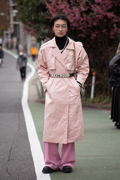 TOKYO, JAPAN - MARCH 19: A guest is seen wearing pastel pink coat, black turtleneck sweater, Vivienn...