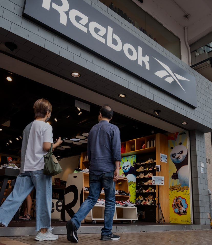 HONG KONG, CHINA - 2021/08/02: Pedestrians walk past the German multinational footwear company brand...