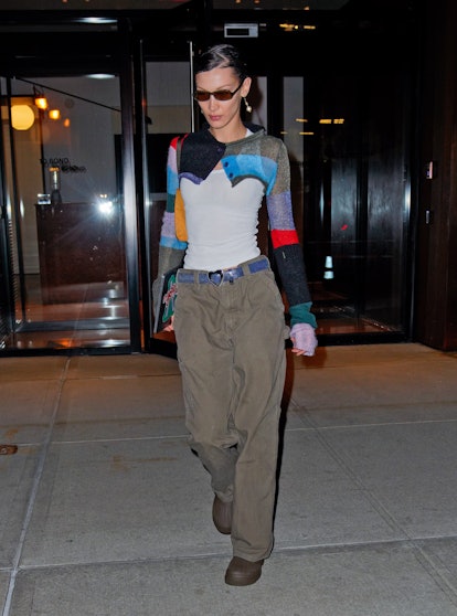 Bella Hadid wears a white tank top with Marc Jacobs striped cardigan.