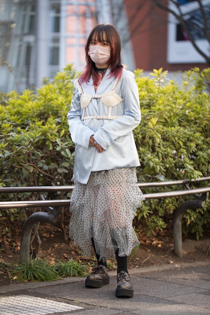 TOKYO, JAPAN - MARCH 15: A guest is seen wearing pastel blue jacket, white leather bra harness accen...