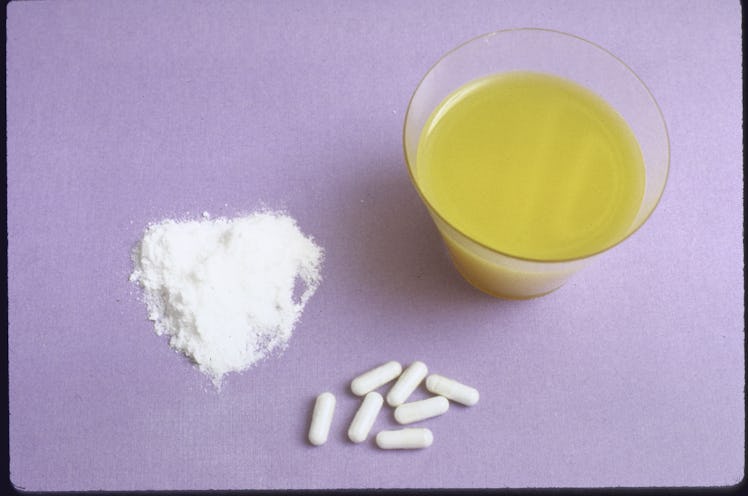 Ecstasy pills, powder, and a glass of orange juice 