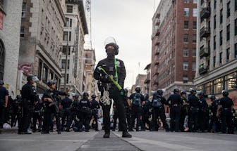 Los Angeles, CA, Tuesday, June 2, 2020 - LAPD officer Decote watches for people tossing debris from ...