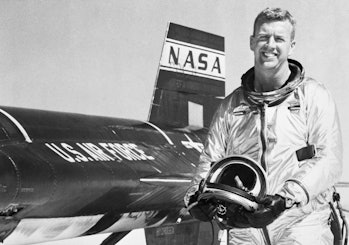 Test pilot Joseph A. Walker smiles as he stands beside an X-15 rocket plane in which he flew at a re...