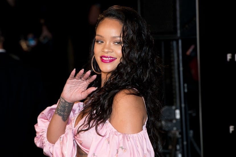 Rihanna wearing a pink top. 